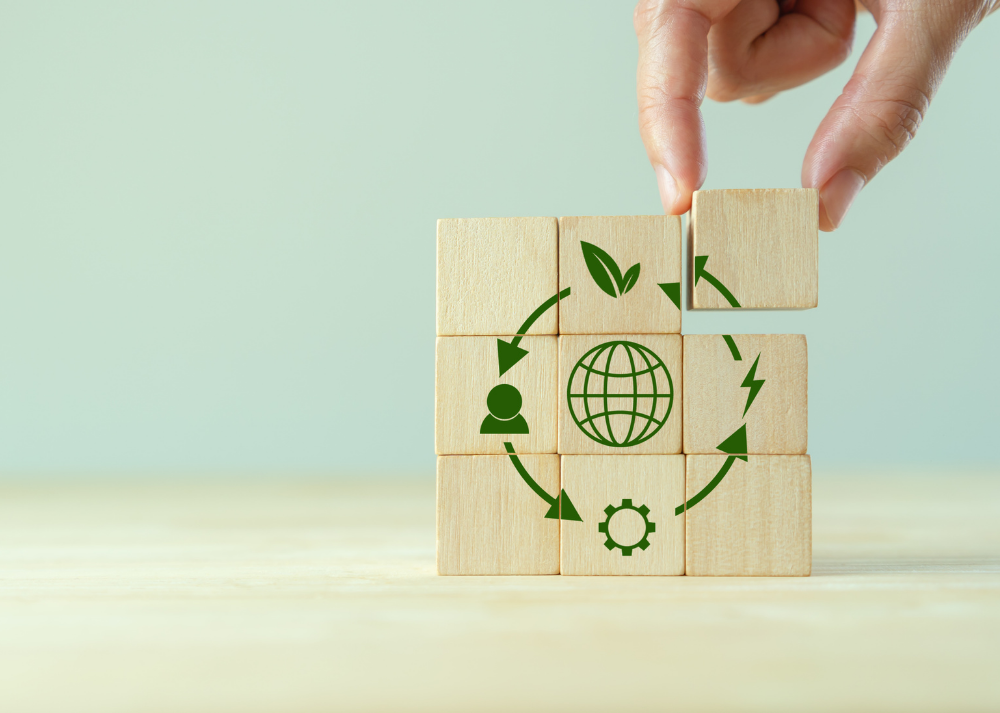 hand placing blocks with icons showing how the circular economy works