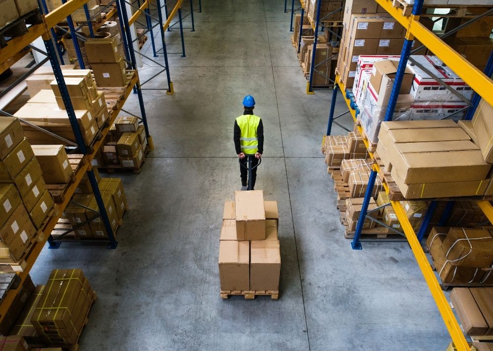 worker pulling excess inventory dead stock to liquidate into cash